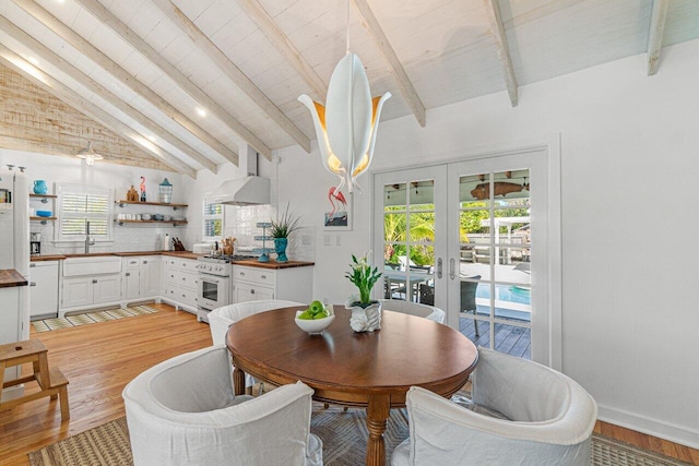 dining space with high vaulted ceiling, french doors, sink, beamed ceiling, and light hardwood / wood-style floors