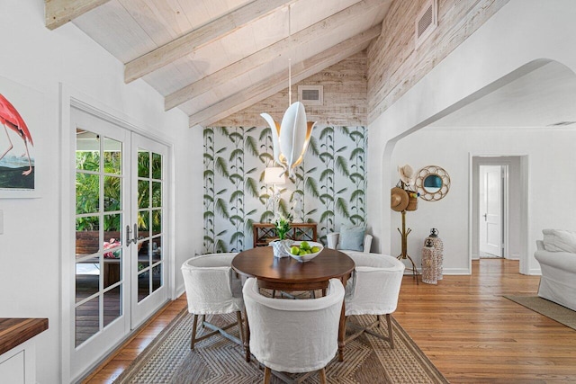 dining area featuring french doors, wood ceiling, wood-type flooring, beam ceiling, and high vaulted ceiling