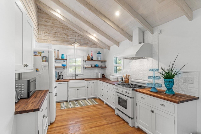 kitchen with butcher block countertops, light hardwood / wood-style floors, white appliances, white cabinets, and exhaust hood