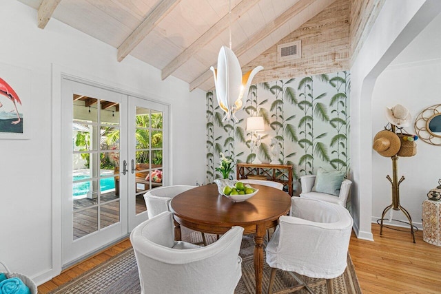 dining room featuring hardwood / wood-style floors, vaulted ceiling with beams, wooden ceiling, and french doors