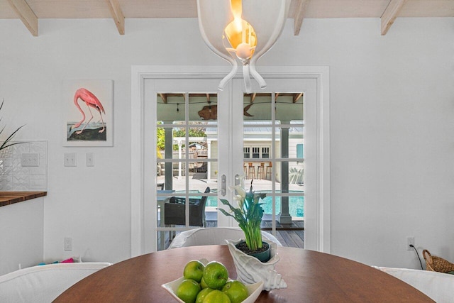 dining area with beamed ceiling and french doors