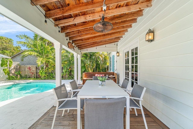 view of patio with a fenced in pool, ceiling fan, and french doors