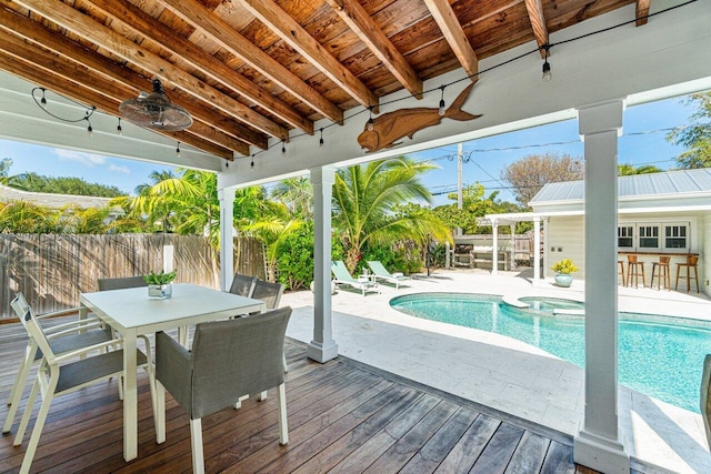 view of pool with ceiling fan, an outdoor bar, an in ground hot tub, and a deck