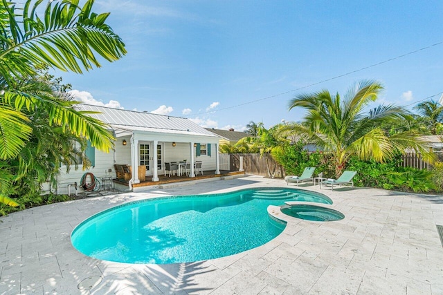 view of pool with an in ground hot tub and a patio area