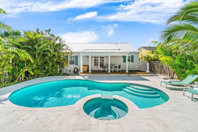 view of pool featuring an in ground hot tub and a patio area