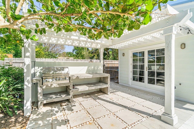 view of patio / terrace with a pergola, exterior kitchen, and french doors