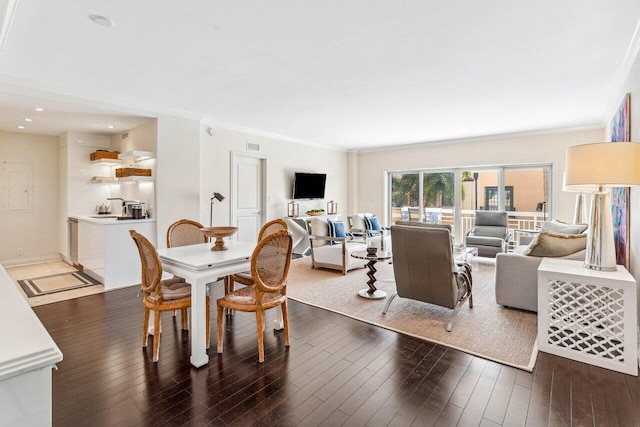 dining area with crown molding and dark wood-type flooring