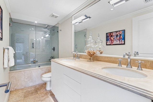 full bathroom featuring vanity, toilet, ornamental molding, and enclosed tub / shower combo