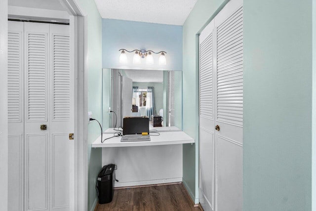 bathroom featuring a textured ceiling and hardwood / wood-style flooring