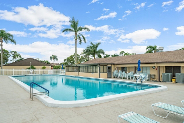 view of swimming pool featuring a patio area and central AC unit