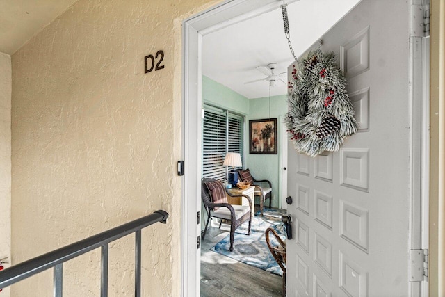 doorway to property featuring ceiling fan