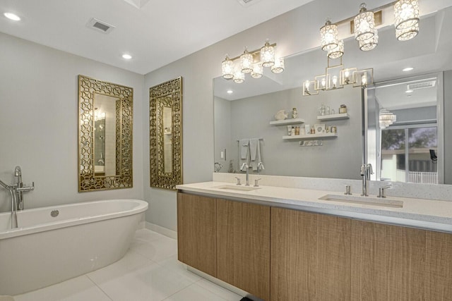 bathroom with tile patterned flooring, vanity, and a bathing tub