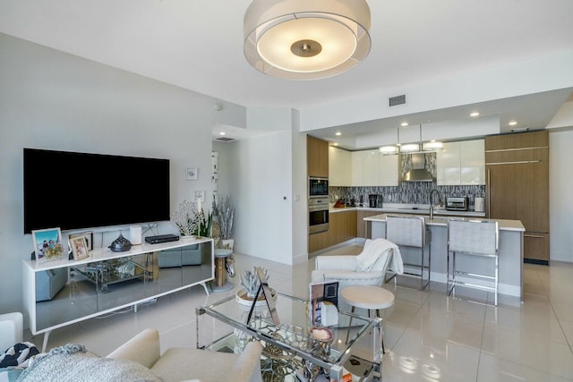 living room featuring light tile patterned flooring and sink