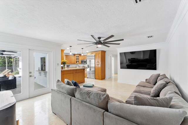 kitchen with appliances with stainless steel finishes, a textured ceiling, and light stone counters