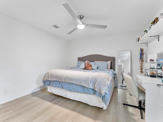 bedroom with light hardwood / wood-style floors and ceiling fan