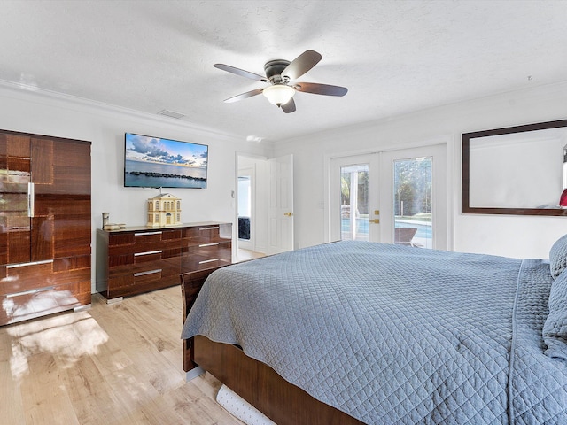 bedroom with french doors, a textured ceiling, light wood-type flooring, access to outside, and ceiling fan