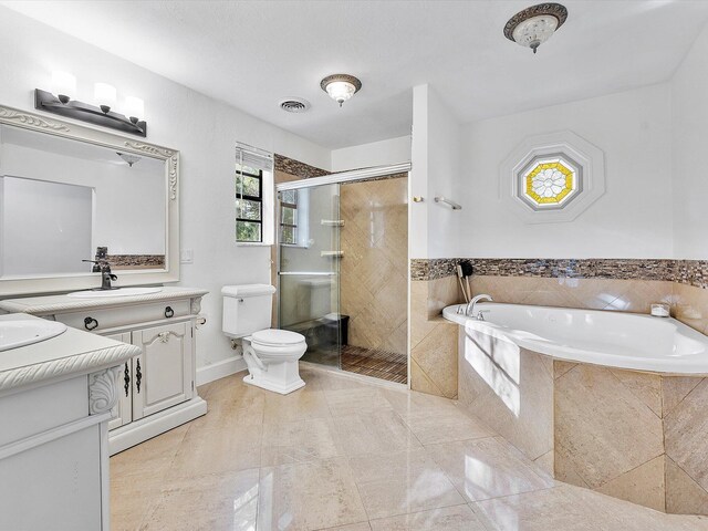 full bathroom with vanity, toilet, and independent shower and bath