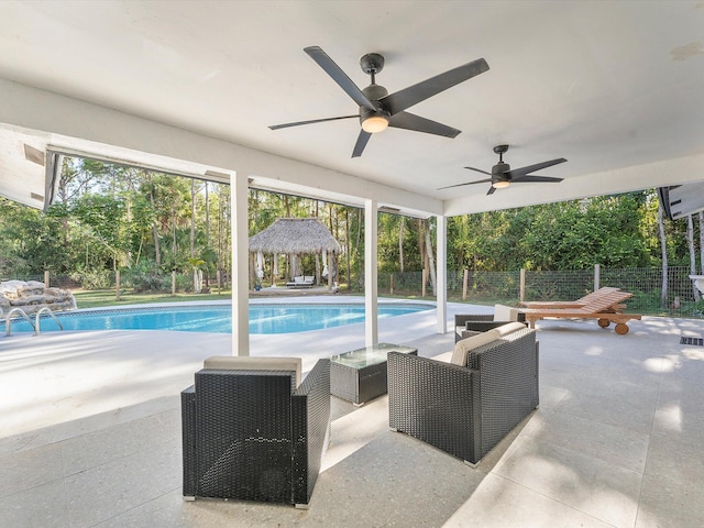 view of swimming pool with a gazebo, ceiling fan, and a patio