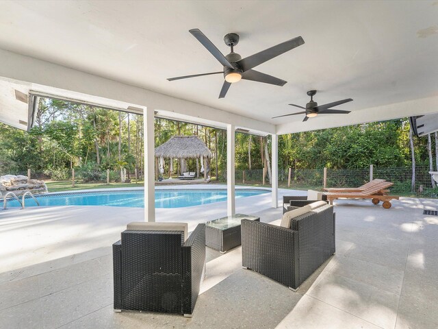 view of swimming pool with french doors, an outdoor living space, ceiling fan, and a patio area