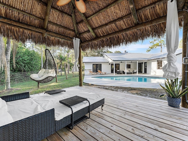 view of pool featuring a gazebo, a wooden deck, and ceiling fan