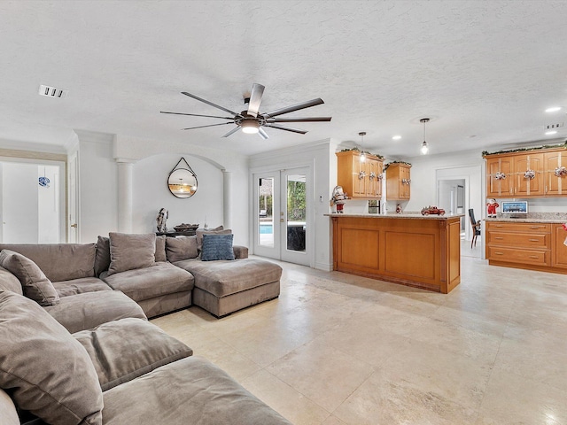 living room with french doors and a textured ceiling