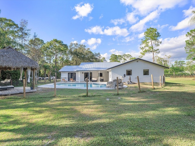 back of house with a yard and a gazebo