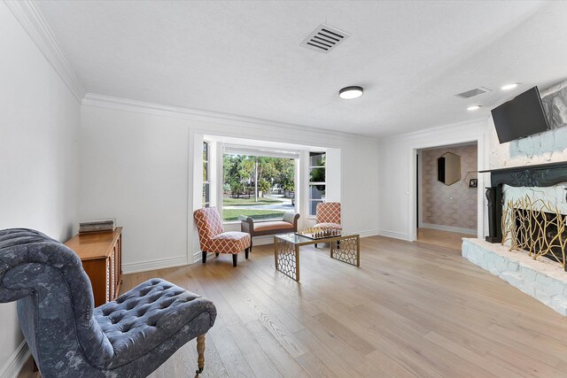 living room featuring ornamental molding, a textured ceiling, ceiling fan, and french doors