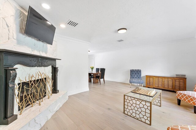 dining space with crown molding, wine cooler, and light hardwood / wood-style flooring