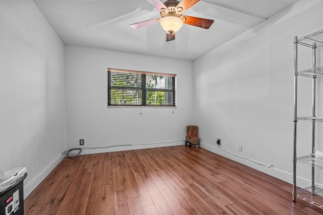 unfurnished room with ceiling fan, a textured ceiling, and hardwood / wood-style flooring