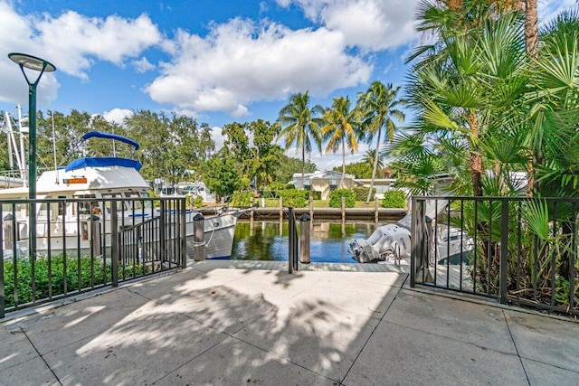 view of patio with a dock and a water view