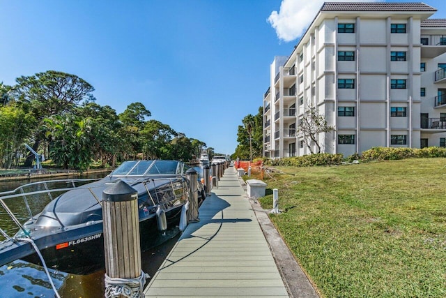 view of dock featuring a lawn