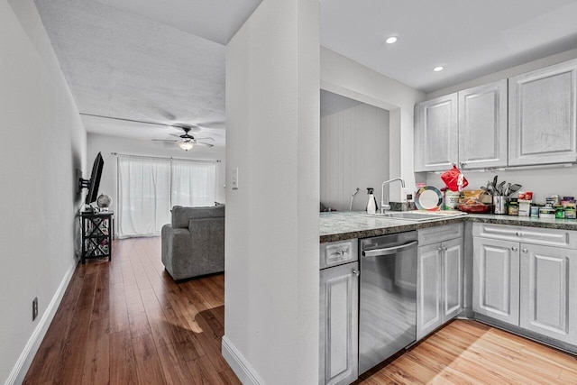 kitchen with light wood-type flooring, ceiling fan, sink, dishwasher, and white cabinetry