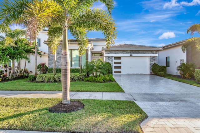 view of front of property with a front yard and a garage