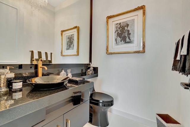 bathroom featuring vanity, a chandelier, and toilet