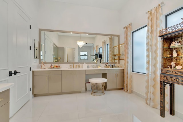 bathroom featuring tile patterned floors, vanity, and a chandelier