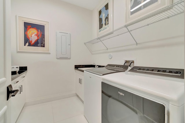 clothes washing area featuring sink, cabinets, electric panel, light tile patterned flooring, and washer and dryer