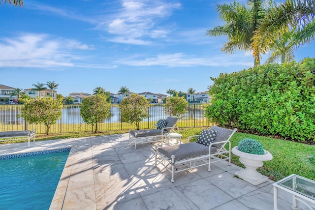 view of pool featuring a patio area and a water view