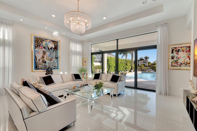 living room featuring a raised ceiling, light tile patterned floors, and a chandelier