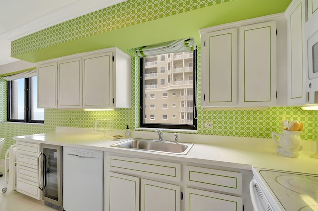 kitchen featuring sink, beverage cooler, white dishwasher, decorative backsplash, and white cabinets