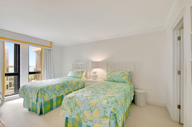 carpeted bedroom with ornamental molding