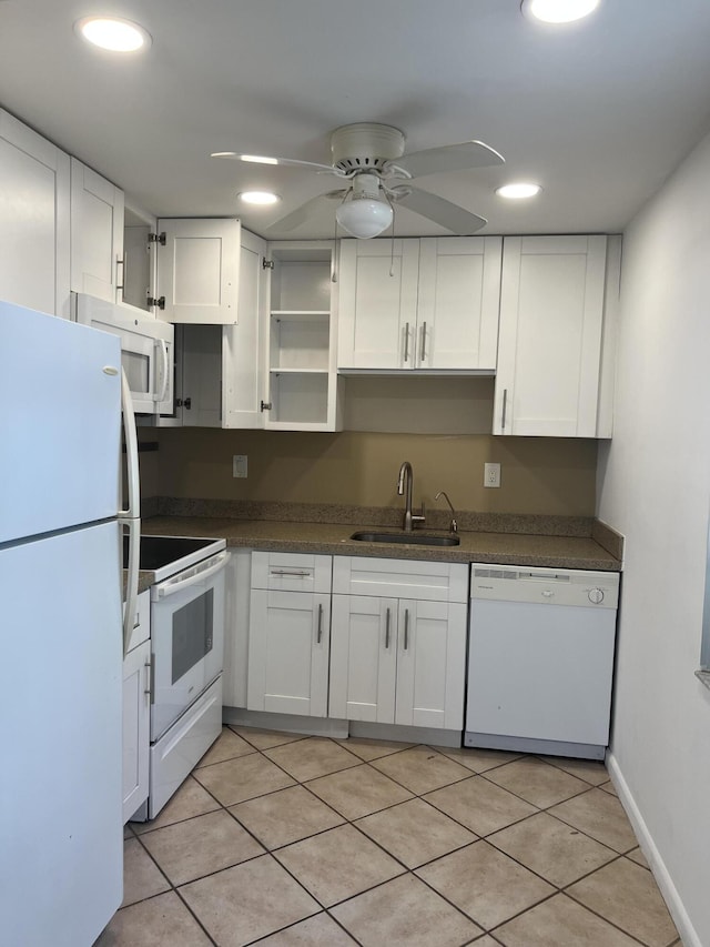 kitchen with white appliances, white cabinets, sink, ceiling fan, and light tile patterned floors