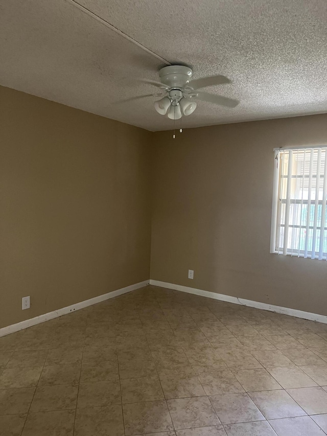 unfurnished room featuring light tile patterned floors, a textured ceiling, and ceiling fan