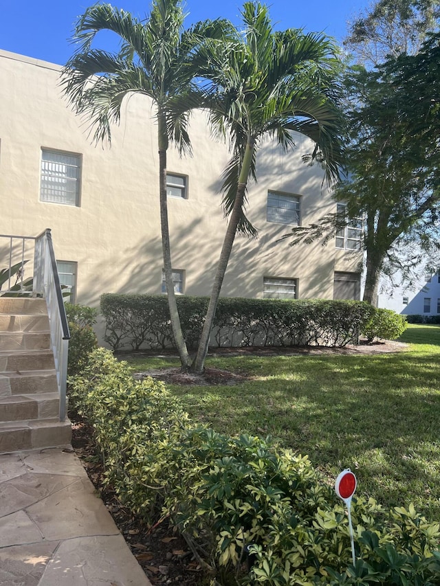 886 Flanders S, Delray Beach, FL 33484 - view of property exterior with stucco siding and a yard