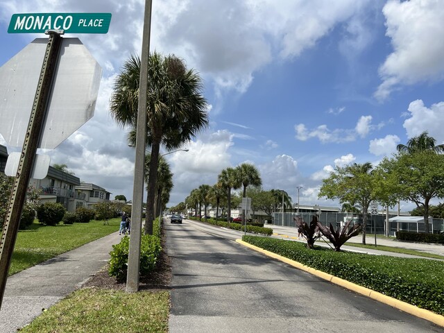 886 Flanders S, Delray Beach, FL 33484 - view of asphalt road with street lighting, sidewalks, and curbs