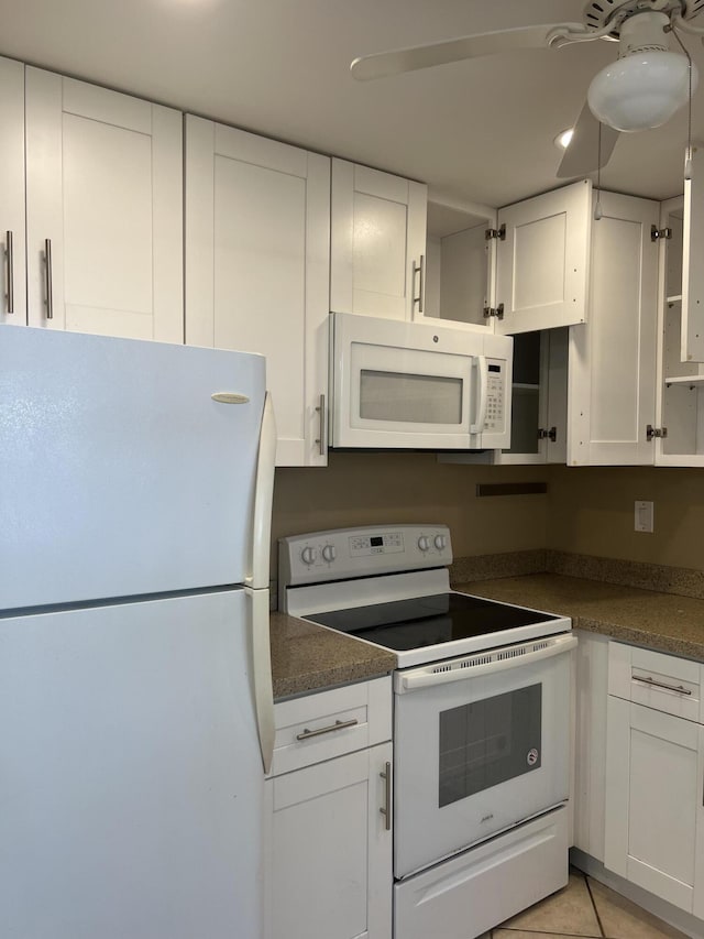 kitchen featuring white cabinets, ceiling fan, white appliances, and light tile patterned floors