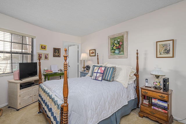 bedroom featuring light colored carpet and a textured ceiling