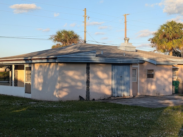 rear view of house featuring a patio area and a yard