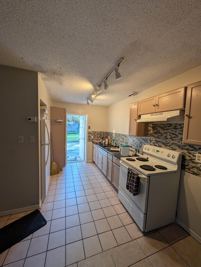 kitchen with light tile patterned flooring, rail lighting, white electric range oven, and fridge