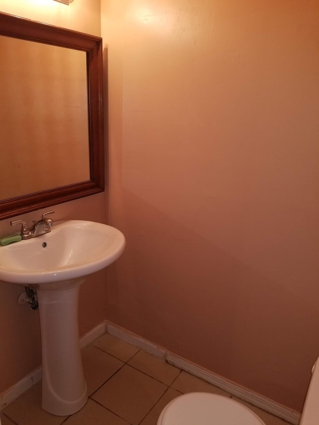 bathroom with toilet and tile patterned flooring