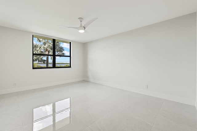 unfurnished room featuring ceiling fan and light tile patterned flooring